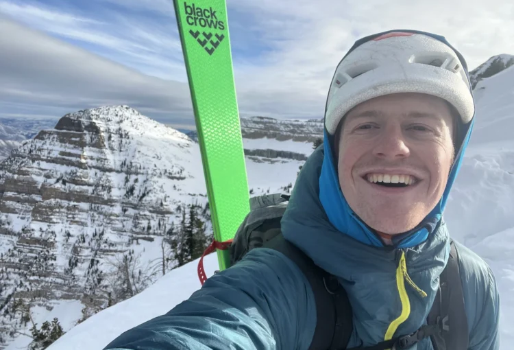 Will McKay profile photo with skis on backpack in winter mountains